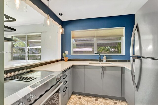 517 S 19th Ave, Hollywood, FL 33020 - kitchen featuring freestanding refrigerator, range, a sink, gray cabinetry, and hanging light fixtures