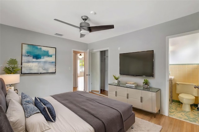 517 S 19th Ave, Hollywood, FL 33020 - bedroom with light wood finished floors, a closet, ensuite bath, and ceiling fan