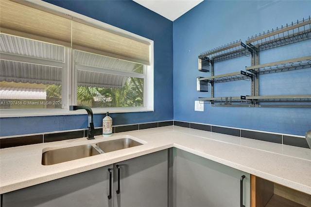 kitchen featuring light stone countertops and sink