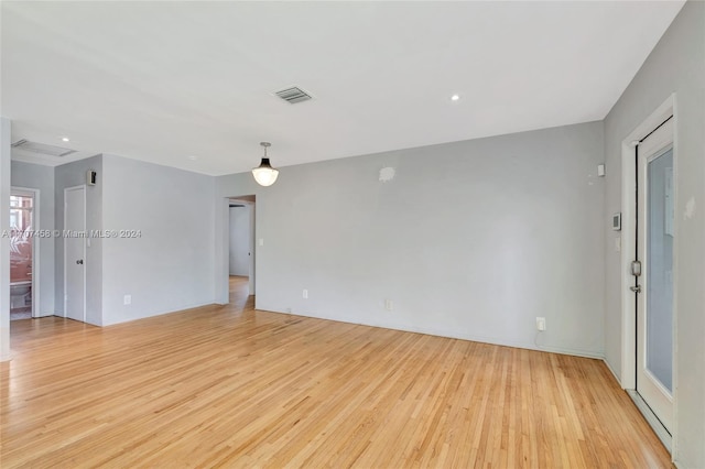 spare room featuring light wood-type flooring