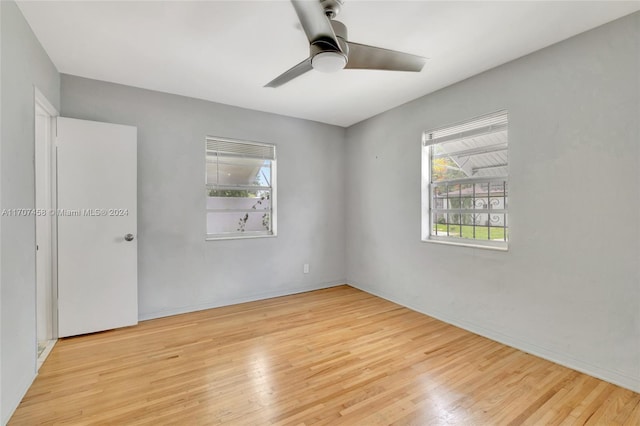 unfurnished room with ceiling fan, plenty of natural light, and light hardwood / wood-style floors