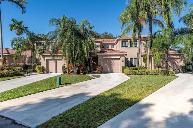 mediterranean / spanish-style house with a front yard and a garage