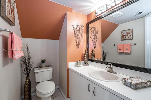 bathroom featuring tile patterned floors, vanity, toilet, and vaulted ceiling