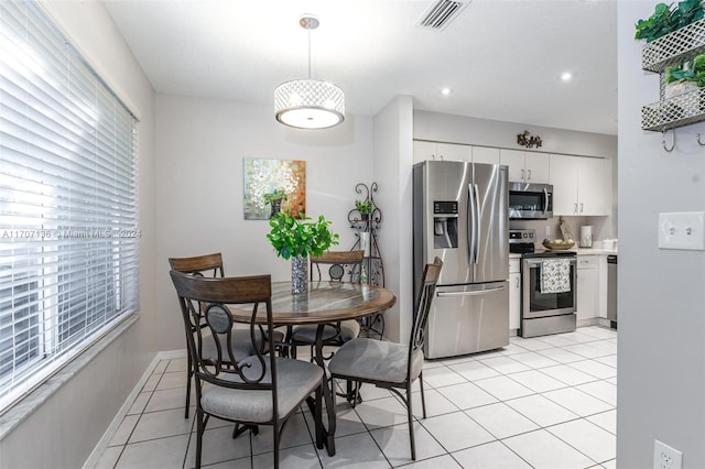 tiled dining space with a wealth of natural light