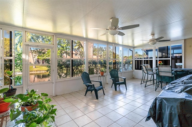 sunroom / solarium featuring ceiling fan