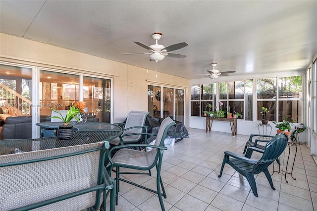 sunroom / solarium featuring ceiling fan