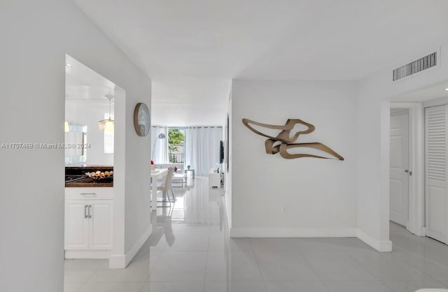 hall featuring light tile patterned floors