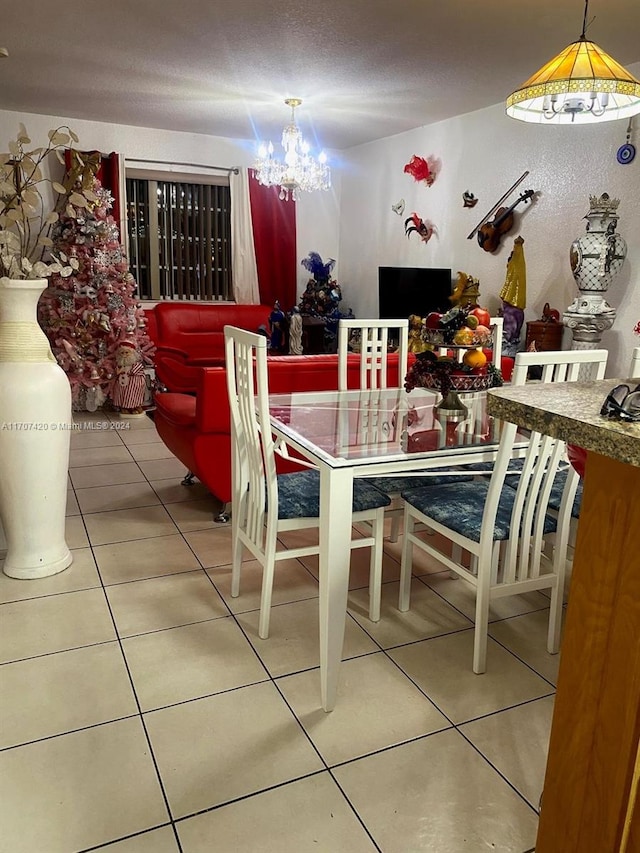 tiled dining space with an inviting chandelier