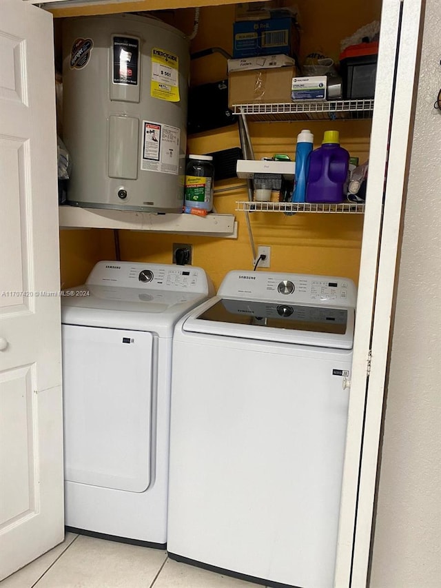 washroom featuring tile patterned flooring, electric water heater, and separate washer and dryer