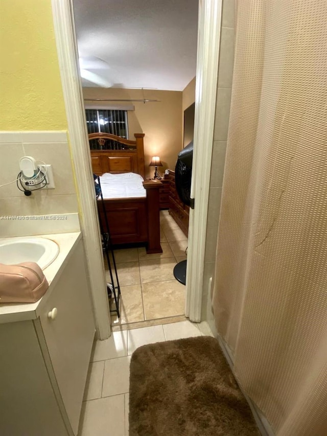 bathroom featuring tile patterned floors, vanity, and walk in shower