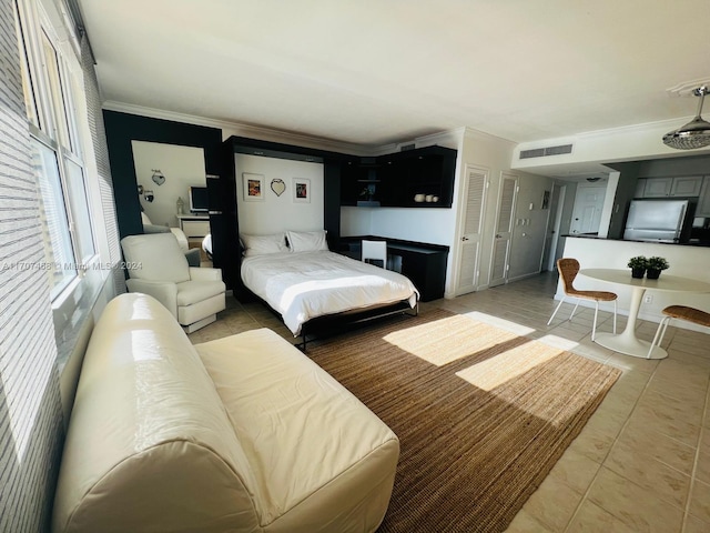 tiled bedroom with stainless steel refrigerator and crown molding