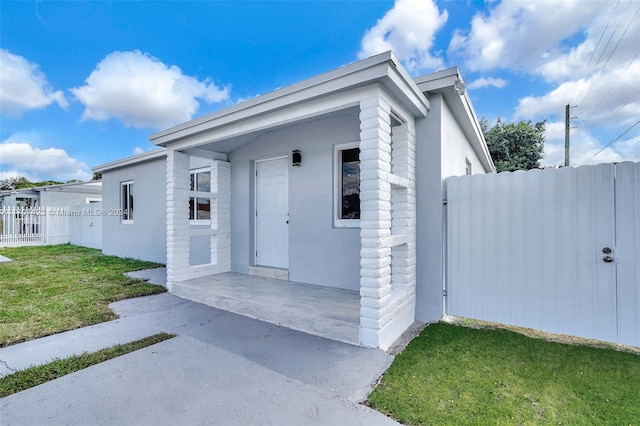 doorway to property featuring a yard