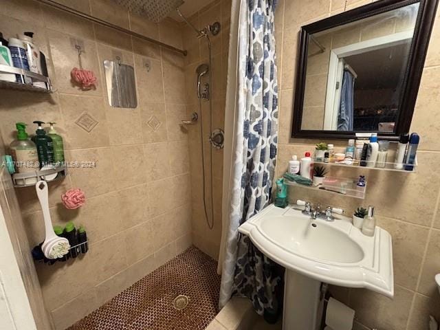 bathroom featuring a shower with curtain and tile walls