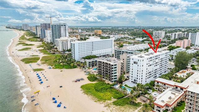 birds eye view of property featuring a water view and a view of the beach