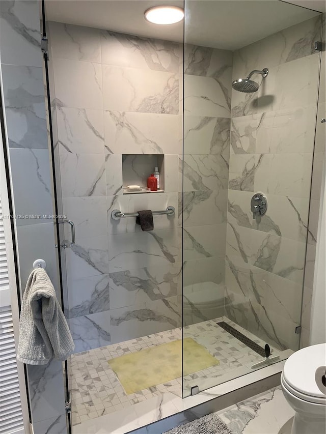 full bathroom featuring a marble finish shower, toilet, and marble finish floor