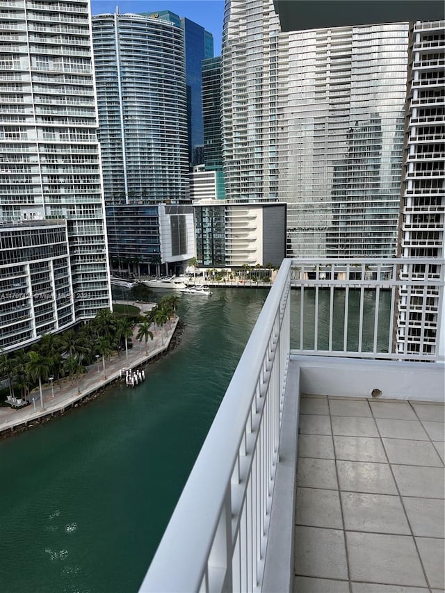 balcony featuring a water view and a view of city