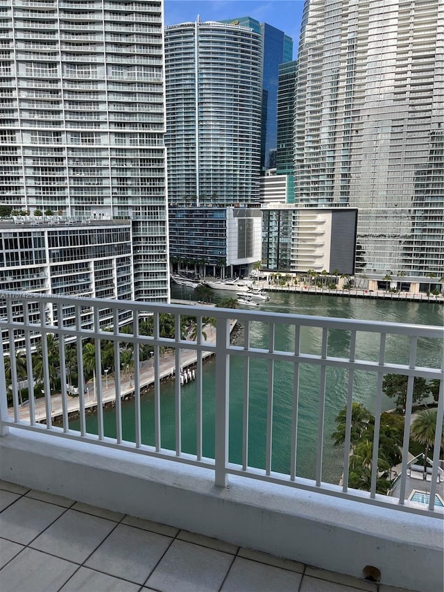 balcony featuring a city view and a water view