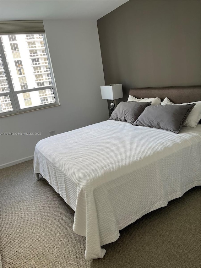 bedroom with carpet and baseboards