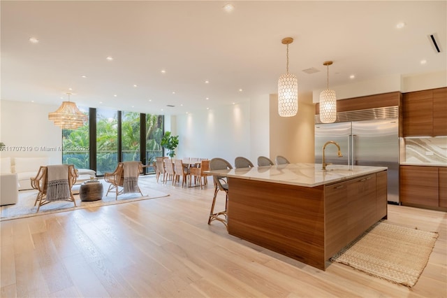 interior space featuring expansive windows, brown cabinets, and modern cabinets