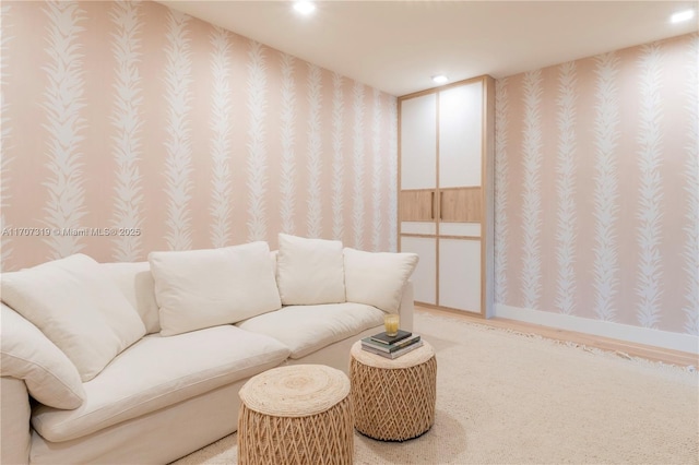 living area featuring baseboards, recessed lighting, light carpet, and wallpapered walls