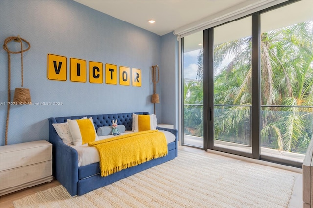 bedroom featuring recessed lighting and expansive windows
