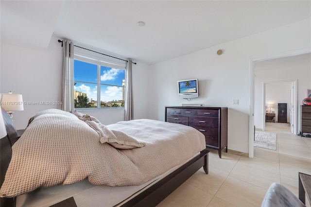 bedroom with light tile patterned floors