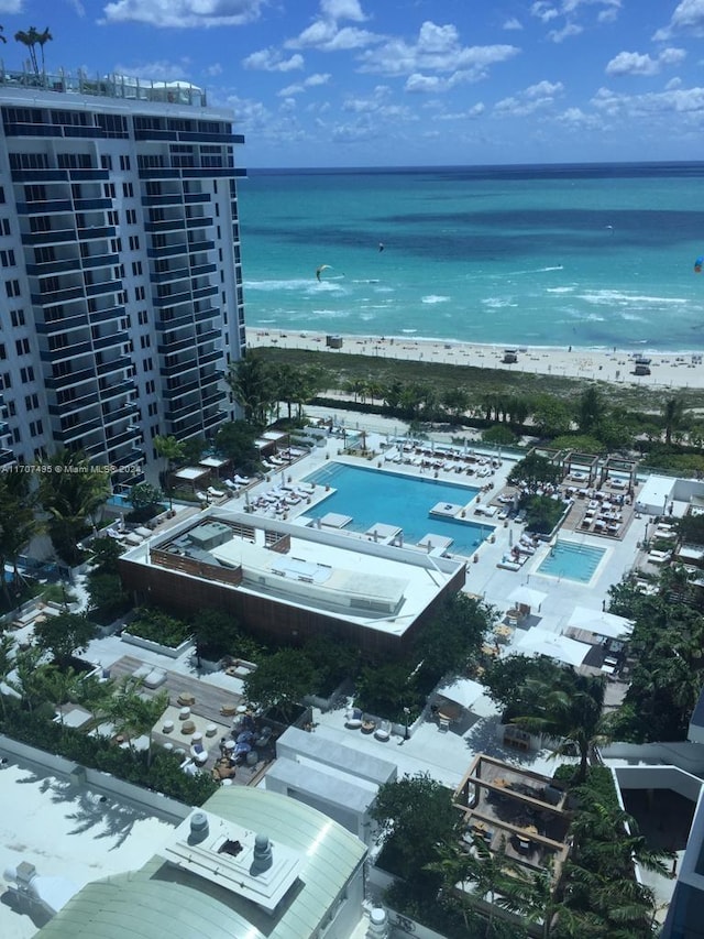 birds eye view of property featuring a water view and a view of the beach