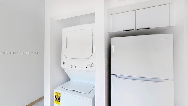 washroom with stacked washing maching and dryer