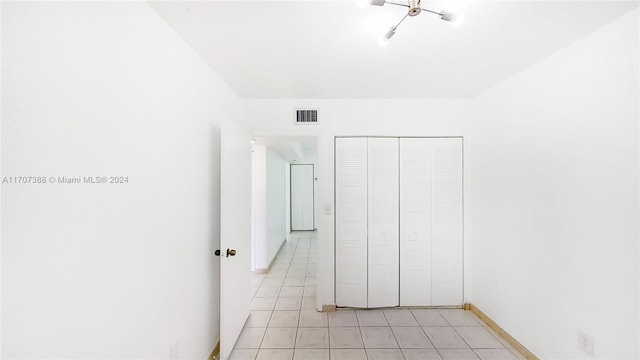 unfurnished bedroom featuring a closet and light tile patterned flooring