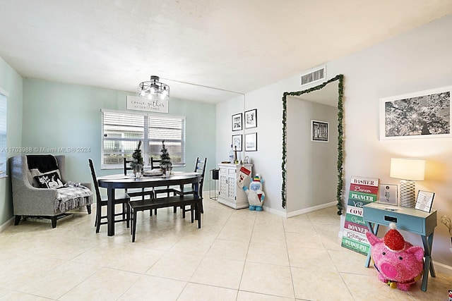 dining space featuring a chandelier and light tile patterned floors