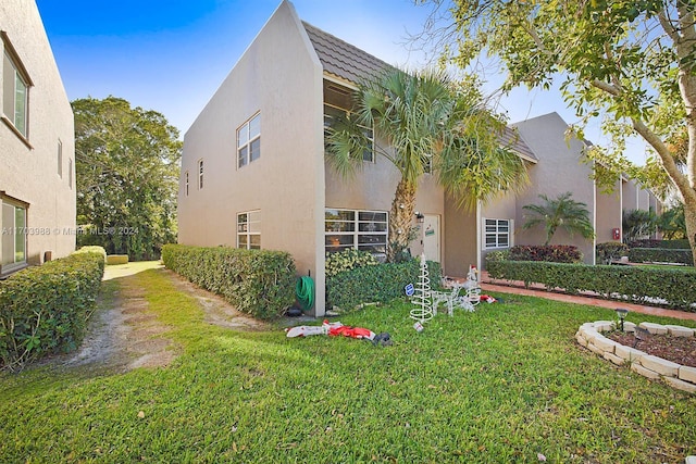 view of property exterior featuring a lawn