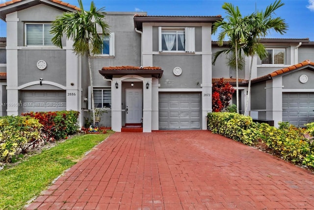 2872 SW 127th Way Unit 1, Miramar, FL 33027 - view of front facade featuring stucco siding, decorative driveway, an attached garage, and a tile roof