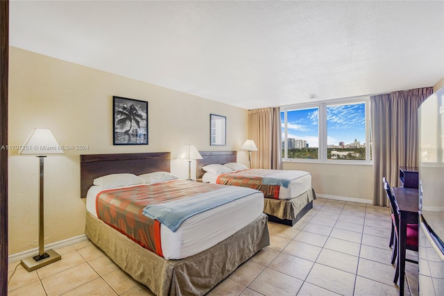 tiled bedroom with a textured ceiling