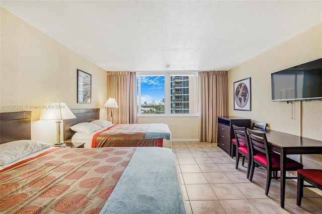 tiled bedroom with a textured ceiling