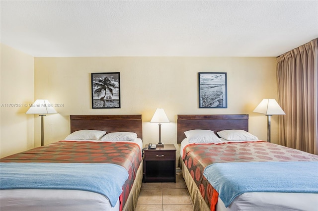 tiled bedroom featuring a textured ceiling