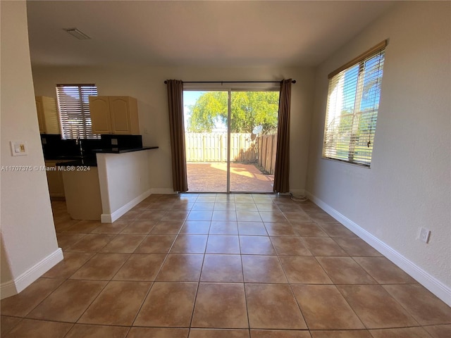 interior space featuring light tile patterned floors and sink