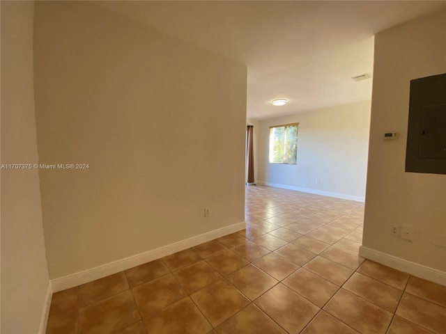 tiled spare room with electric panel