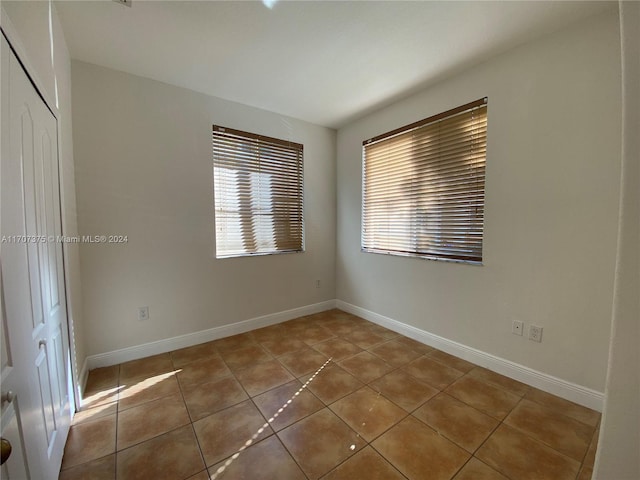 spare room with light tile patterned floors