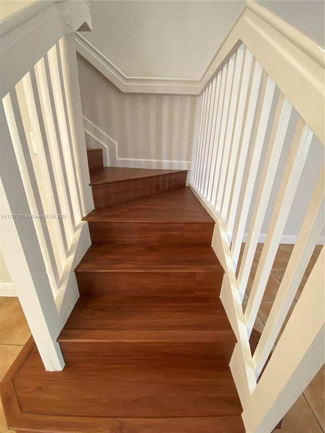 stairs featuring hardwood / wood-style flooring