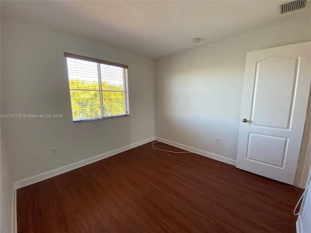 empty room featuring dark hardwood / wood-style flooring