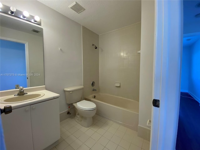 full bathroom with a textured ceiling, vanity, tiled shower / bath combo, tile patterned flooring, and toilet