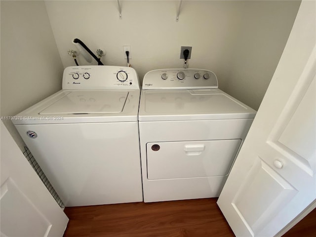 washroom with independent washer and dryer and dark hardwood / wood-style floors