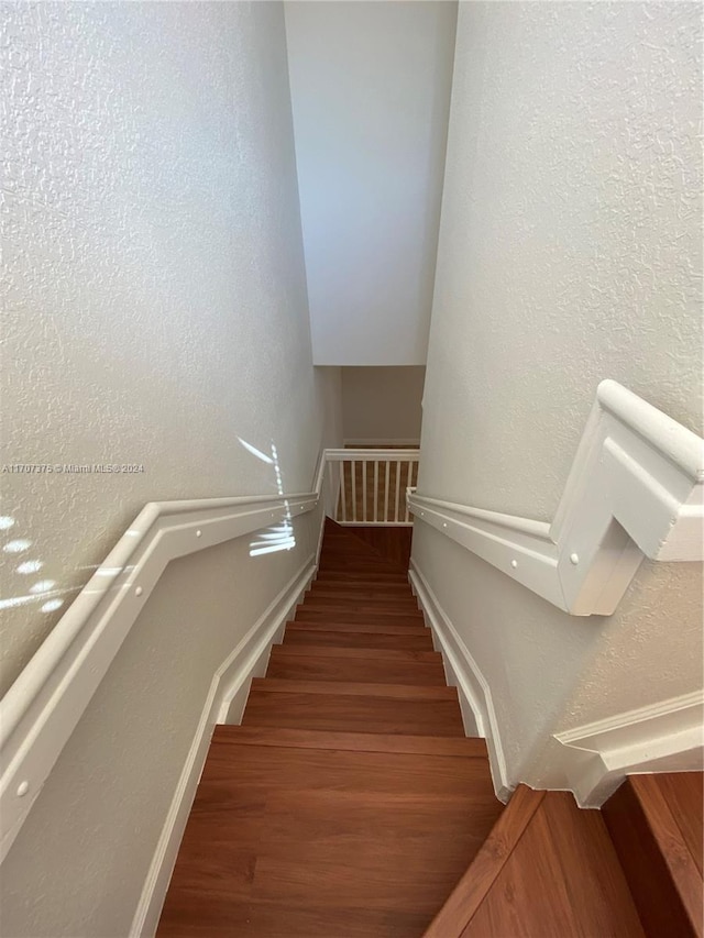 staircase featuring hardwood / wood-style floors