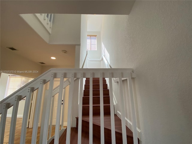 staircase featuring wood-type flooring