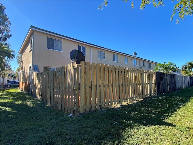 rear view of property with a lawn