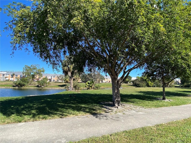 exterior space featuring a water view and a yard