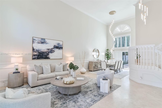 living room featuring crown molding and a towering ceiling