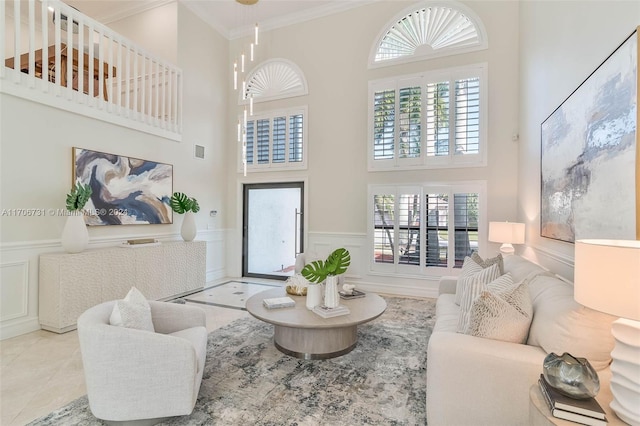 living room with a high ceiling and ornamental molding