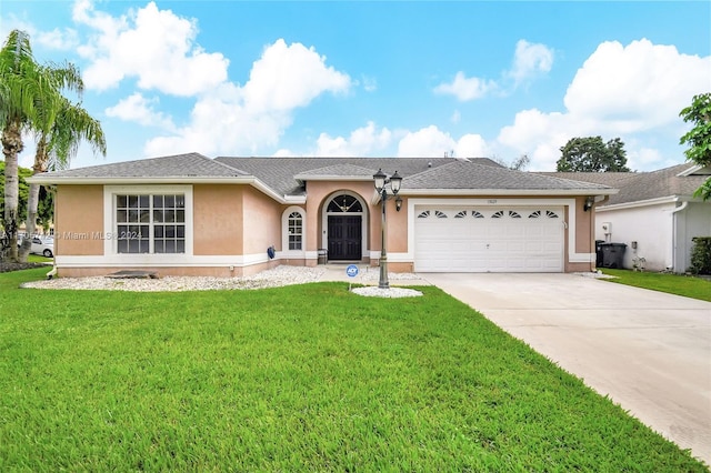 ranch-style home with a garage and a front lawn