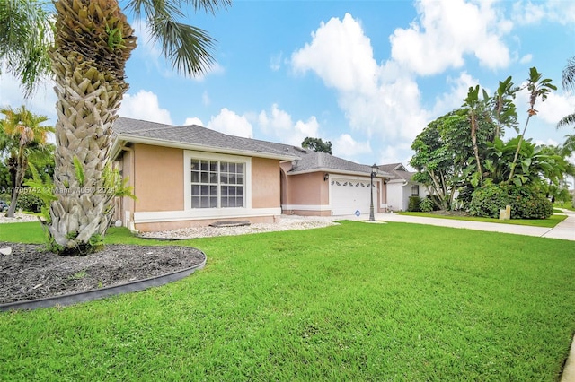 single story home with a garage and a front lawn